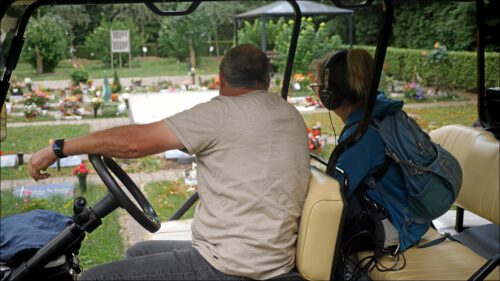 Friedhofsgärtner Harald Bartilla und Redakteurin Julia Thomas von hinten sitzend in einem Golfcart, Blick auf einen von Bartilla und seinem Team gestalteten Teil des Friedhofs – dem Garten der Vielfalt – wo auch extra ein Feld für Fans der Spielvereinigung geschaffen wurde. Friedhofsgärtner Harald Bartilla und Redakteurin Julia Thomas von hinten sitzend in einem Golfcart, Blick auf einen von Bartilla und seinem Team gestalteten Teil des Friedhofs – dem Garten der Vielfalt – wo auch extra ein Feld für Fans der Spielvereinigung geschaffen wurde.